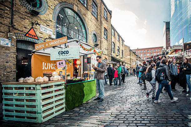 London, United Kingdom - October 10, 2014: Pictured here is a street view of historic Camden Town at the Stables  with visitors visible.  This district in London is a notable and well visited area known for its alternative culture and shopping.